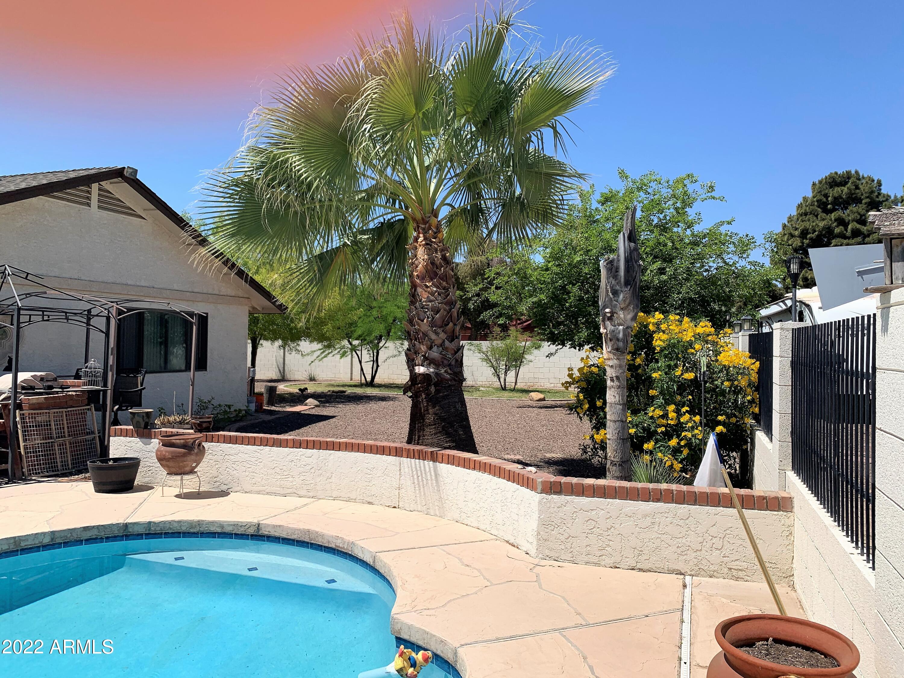 16502 West Magnolia Street Goodyear, AZ 85338 - Photo 46 of 59 a swimming pool with outdoor seating and yard