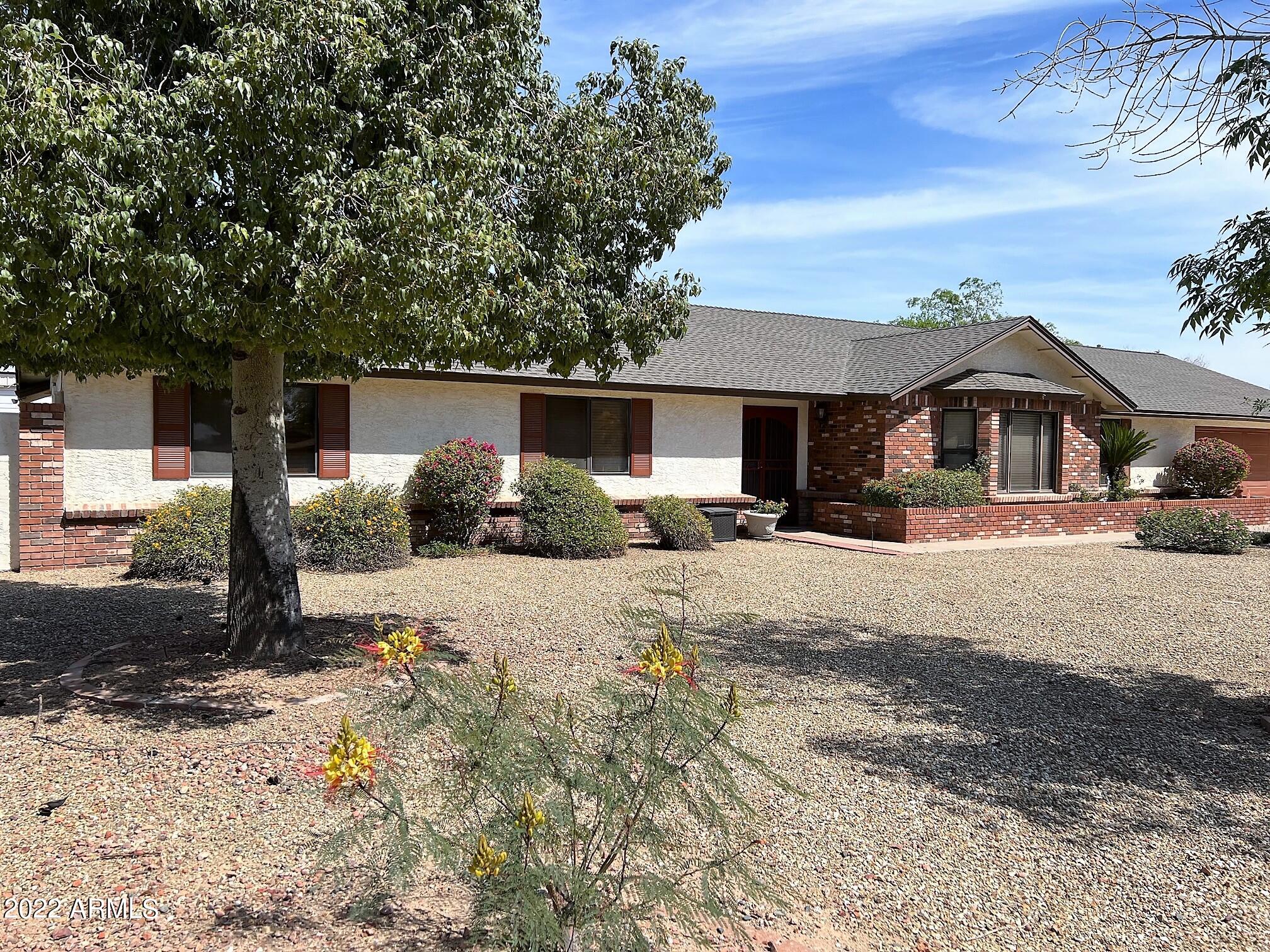 16502 West Magnolia Street Goodyear, AZ 85338 - Photo 58 of 59 a front view of a house with a yard