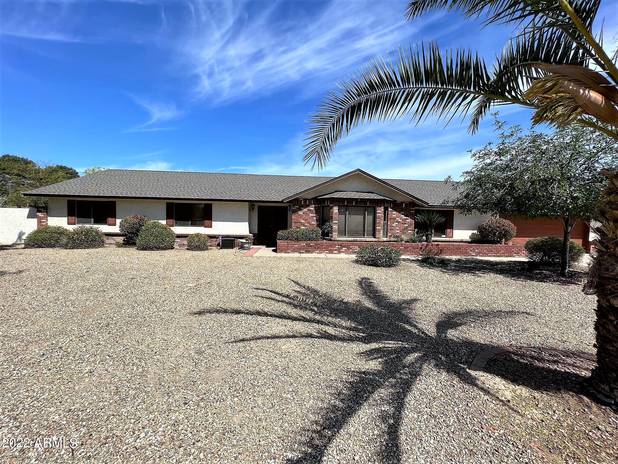 16502 West Magnolia Street Goodyear, AZ 85338 - Photo 59 of 59 a view of swimming pool with outdoor seating and house in the background