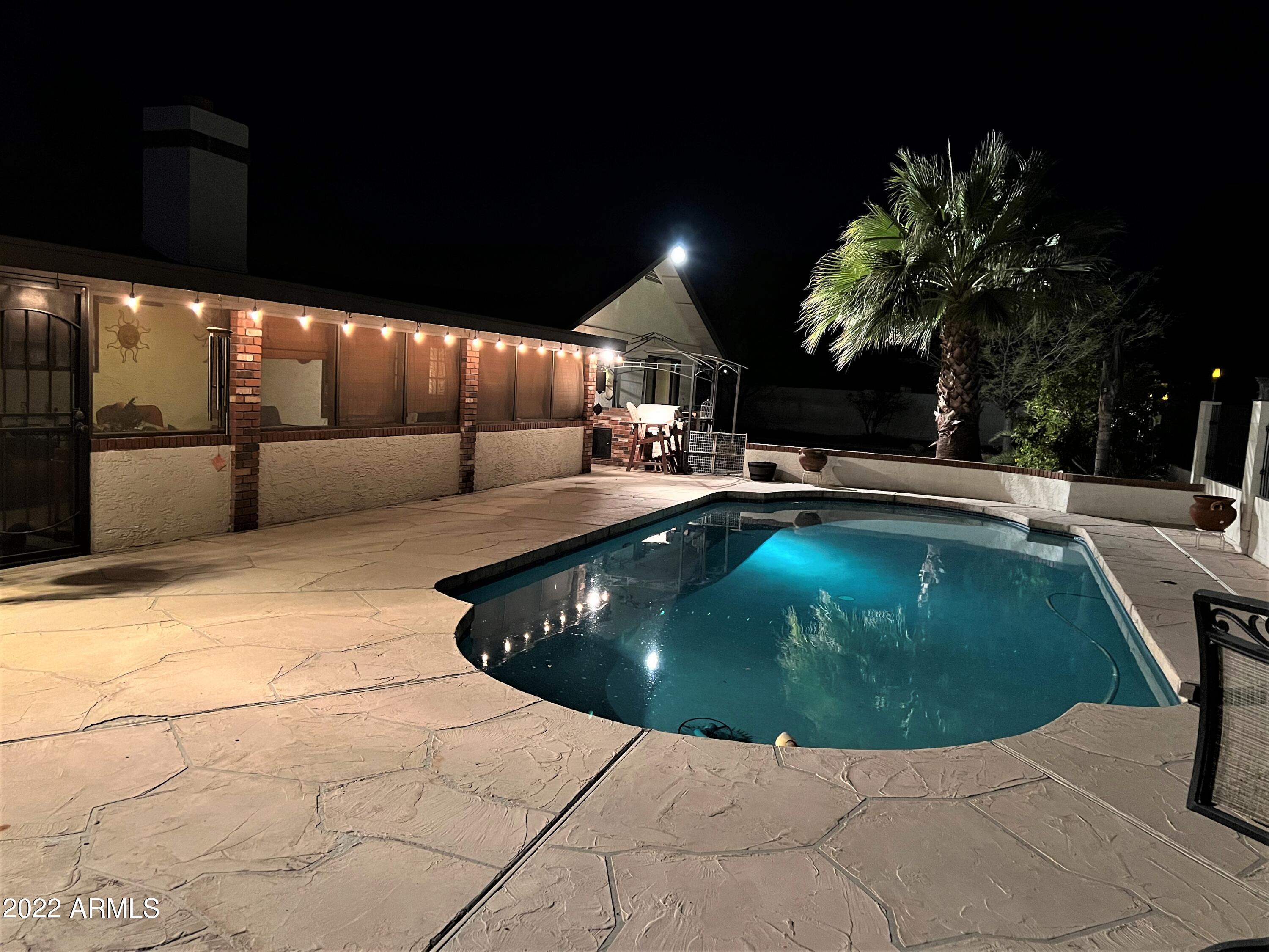 16502 West Magnolia Street Goodyear, AZ 85338 - Photo 6 of 59 a swimming pool with outdoor seating and yard