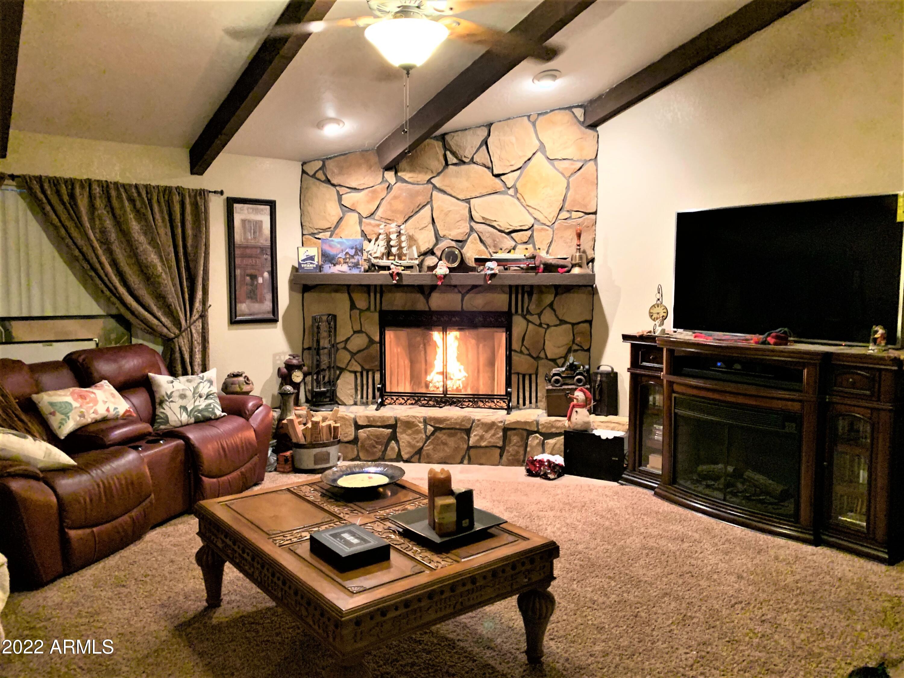 16502 West Magnolia Street Goodyear, AZ 85338 - Photo 8 of 59 a living room with furniture and a flat screen tv