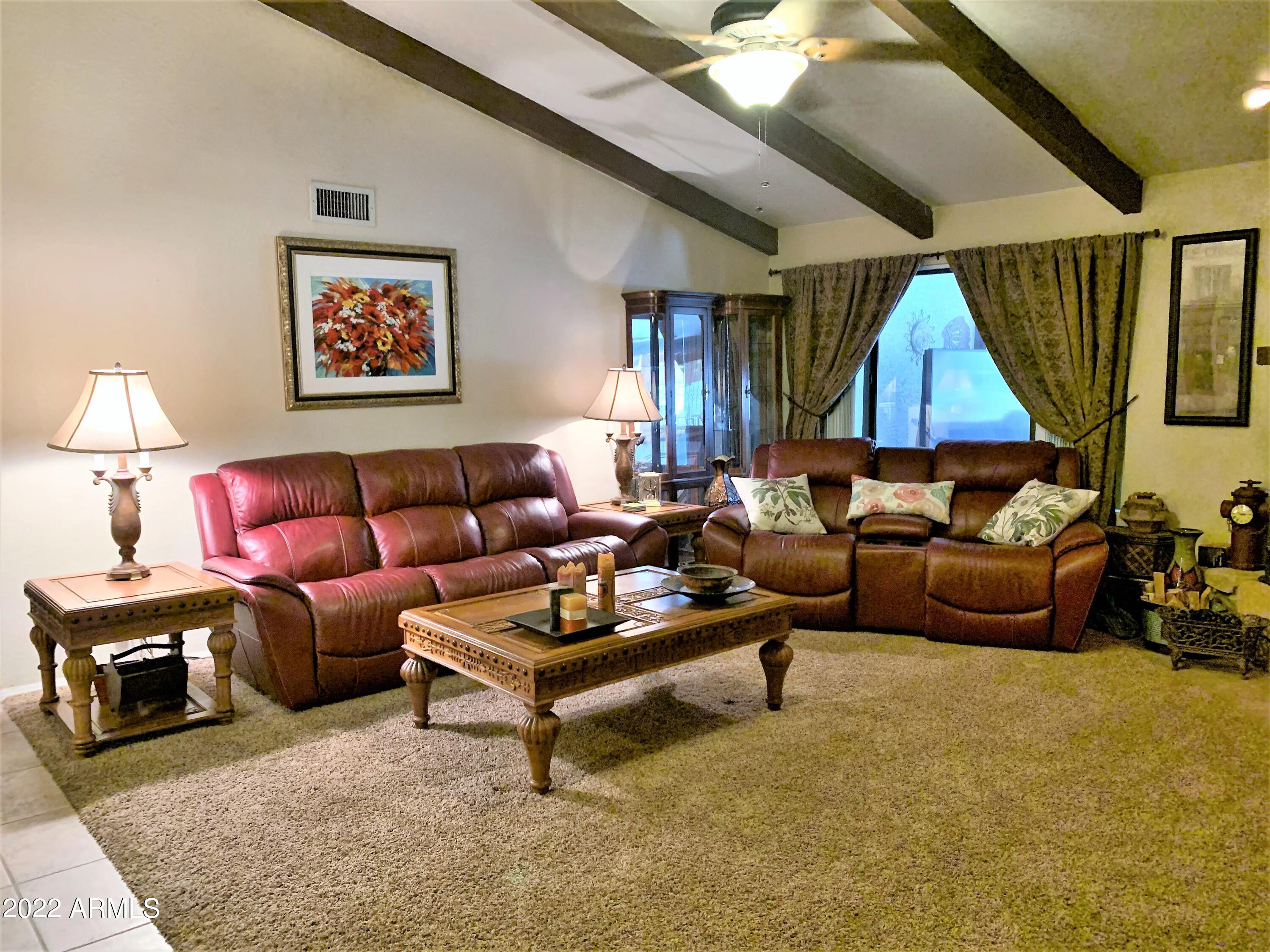 16502 West Magnolia Street Goodyear, AZ 85338 - Photo 9 of 59 a living room with furniture and a flat screen tv