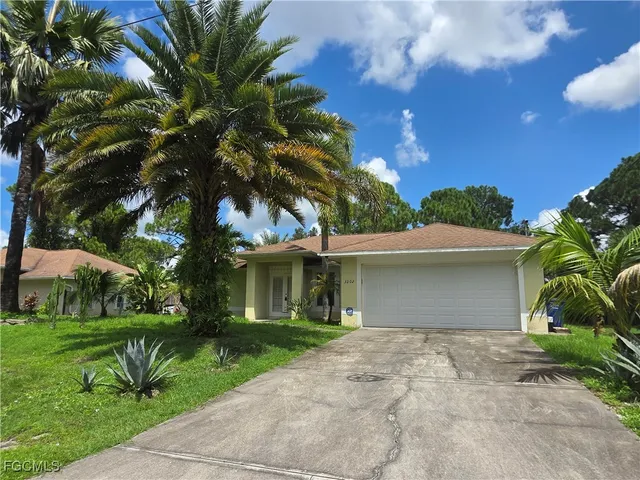 a front view of house with yard and green space