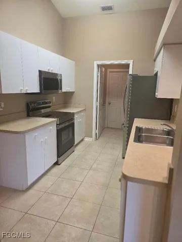 a kitchen with a stove top oven and cabinets