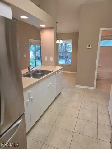 a kitchen with a sink a counter space and a window