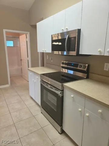 a kitchen with a stove and a microwave