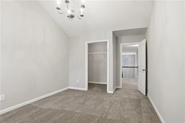 a view of a chandelier in big room and chandelier fan