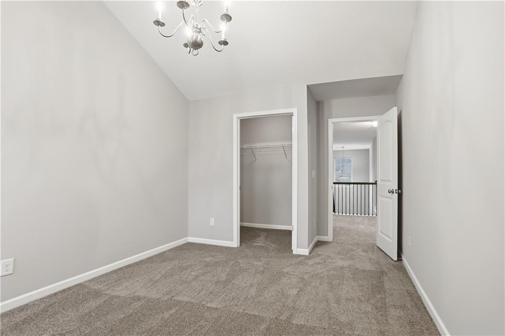 1021 Reddy Farm Lane Grayson, GA 30017 - Photo 13 of 22 a view of a chandelier in big room and chandelier fan
