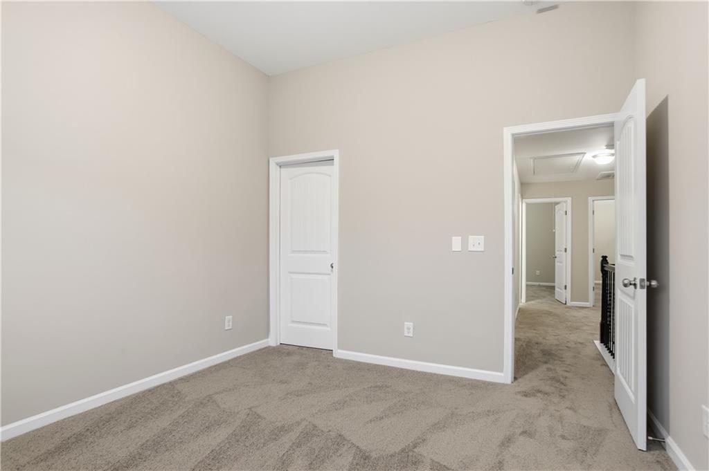 1021 Reddy Farm Lane Grayson, GA 30017 - Photo 15 of 22 an empty room with a hallway