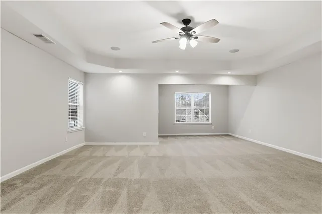 a view of an empty room with a ceiling fan
