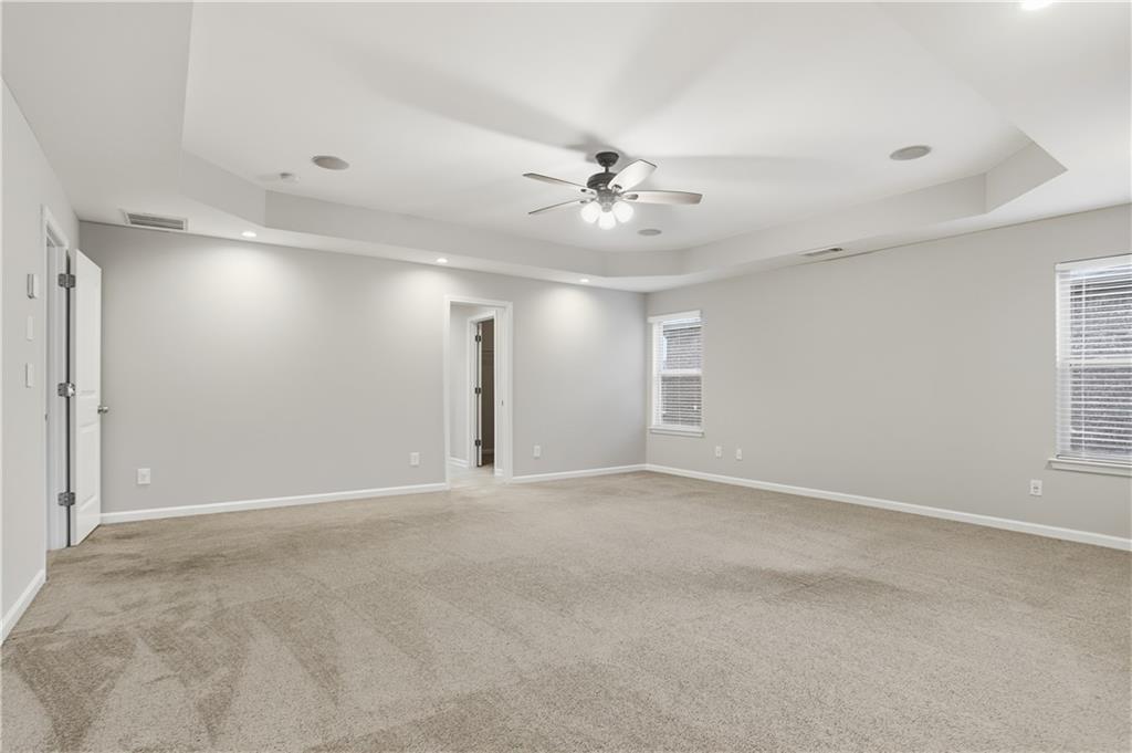 1021 Reddy Farm Lane Grayson, GA 30017 - Photo 17 of 22 a view of an empty room with a ceiling fan