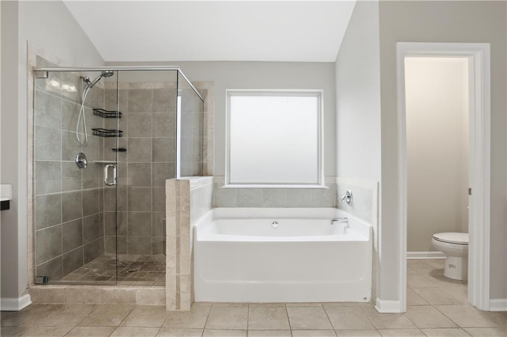 1021 Reddy Farm Lane Grayson, GA 30017 - Photo 19 of 22 a bathroom with a shower and a bathtub