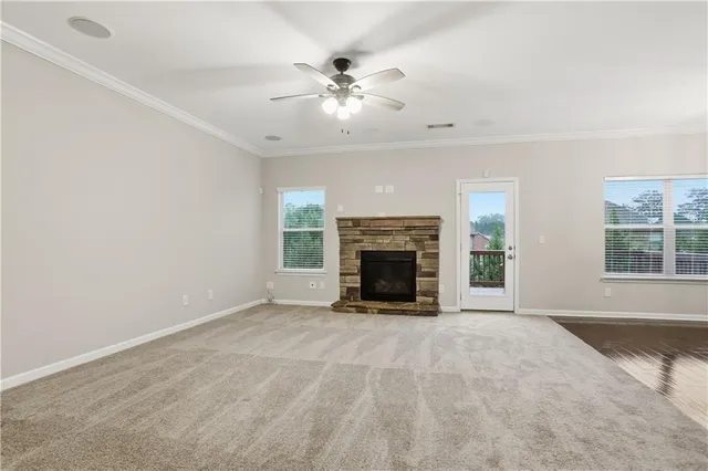 a view of an empty room with window and fire place