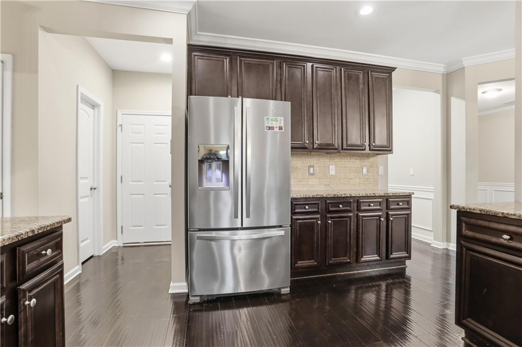 1021 Reddy Farm Lane Grayson, GA 30017 - Photo 7 of 22 a kitchen with kitchen island wooden floors appliances and cabinets