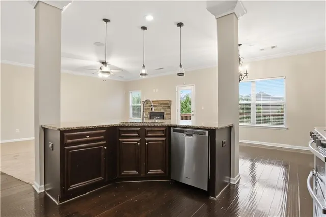 a kitchen with stainless steel appliances granite countertop a stove a sink and a window