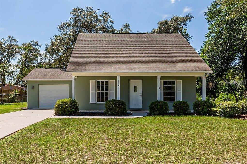 11350 Sheffield Road Spring Hill, FL 34608 - Photo 1 of 1 a front view of house with yard and trees
