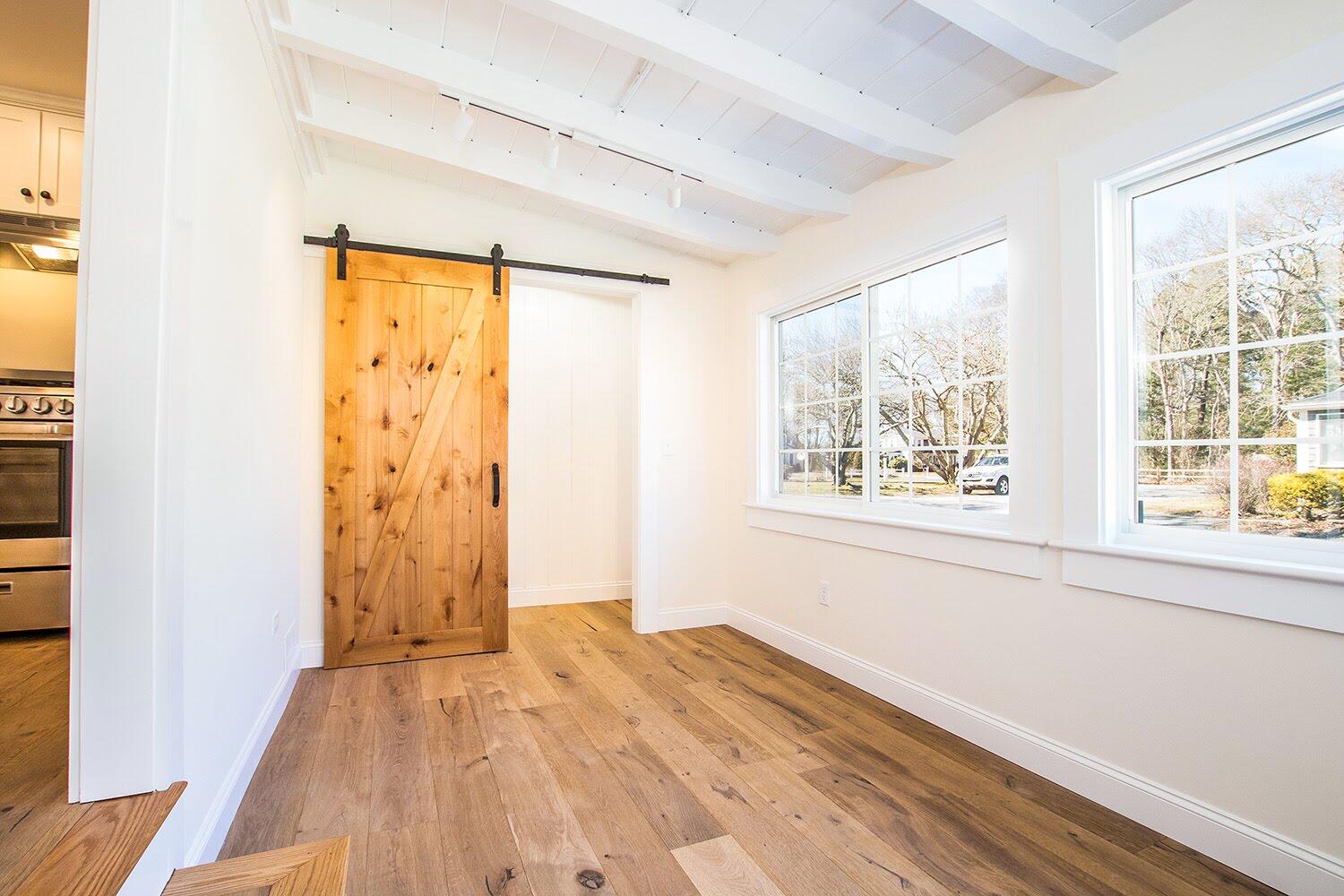 16 2nd Avenue, Unit 5A Osterville, MA 02655 - Photo 18 of 21 an empty room with wooden floor and windows