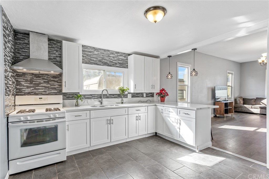 4582 Howard Avenue Riverside, CA 92507 - Photo 1 of 1 a kitchen with a stove sink and cabinets