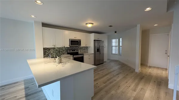 a kitchen with a refrigerator and a sink