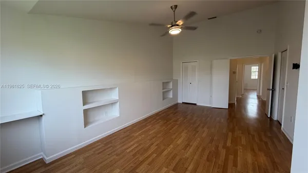 wooden floor in an empty room with a window
