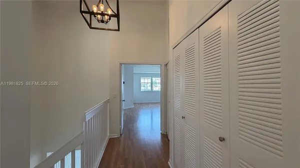 a view of a hallway with wooden floor