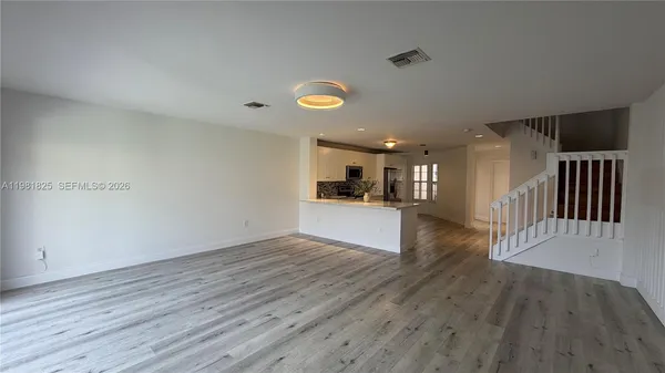 a view of a livingroom with wooden floor
