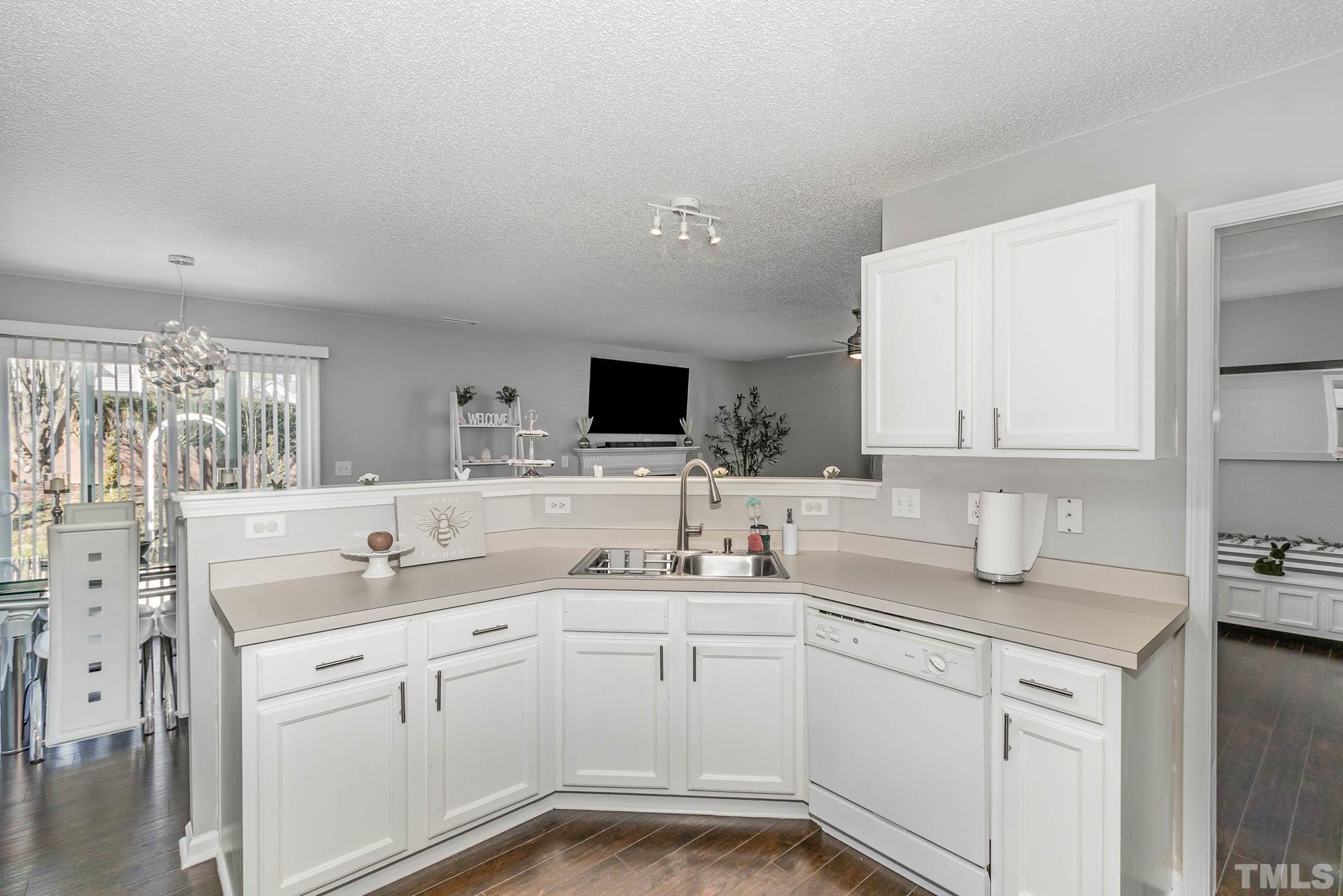 266 Inkster Cove Raleigh, NC 27603 - Photo 11 of 30 a kitchen with a sink stove and cabinets