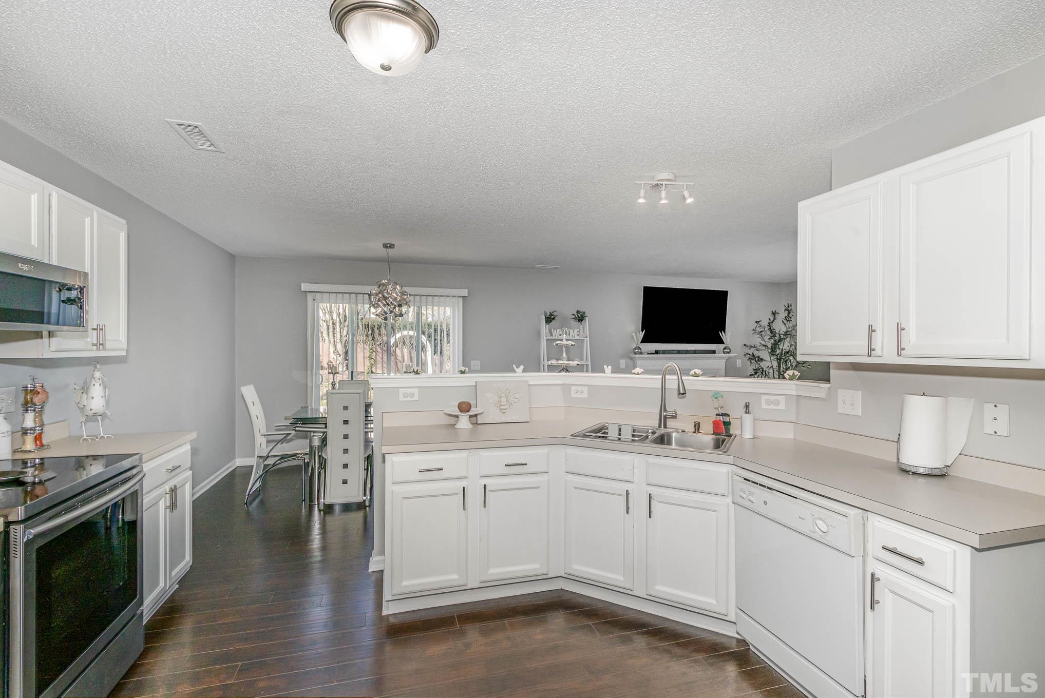 266 Inkster Cove Raleigh, NC 27603 - Photo 13 of 30 a kitchen with a sink stove and microwave