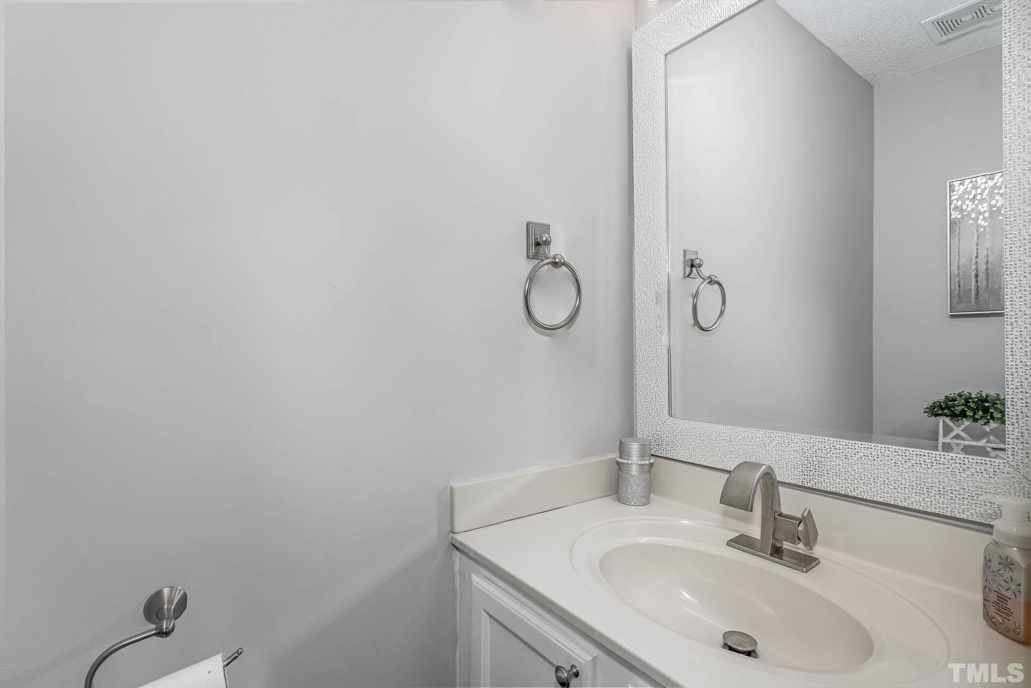 266 Inkster Cove Raleigh, NC 27603 - Photo 14 of 30 a bathroom with a sink and mirror