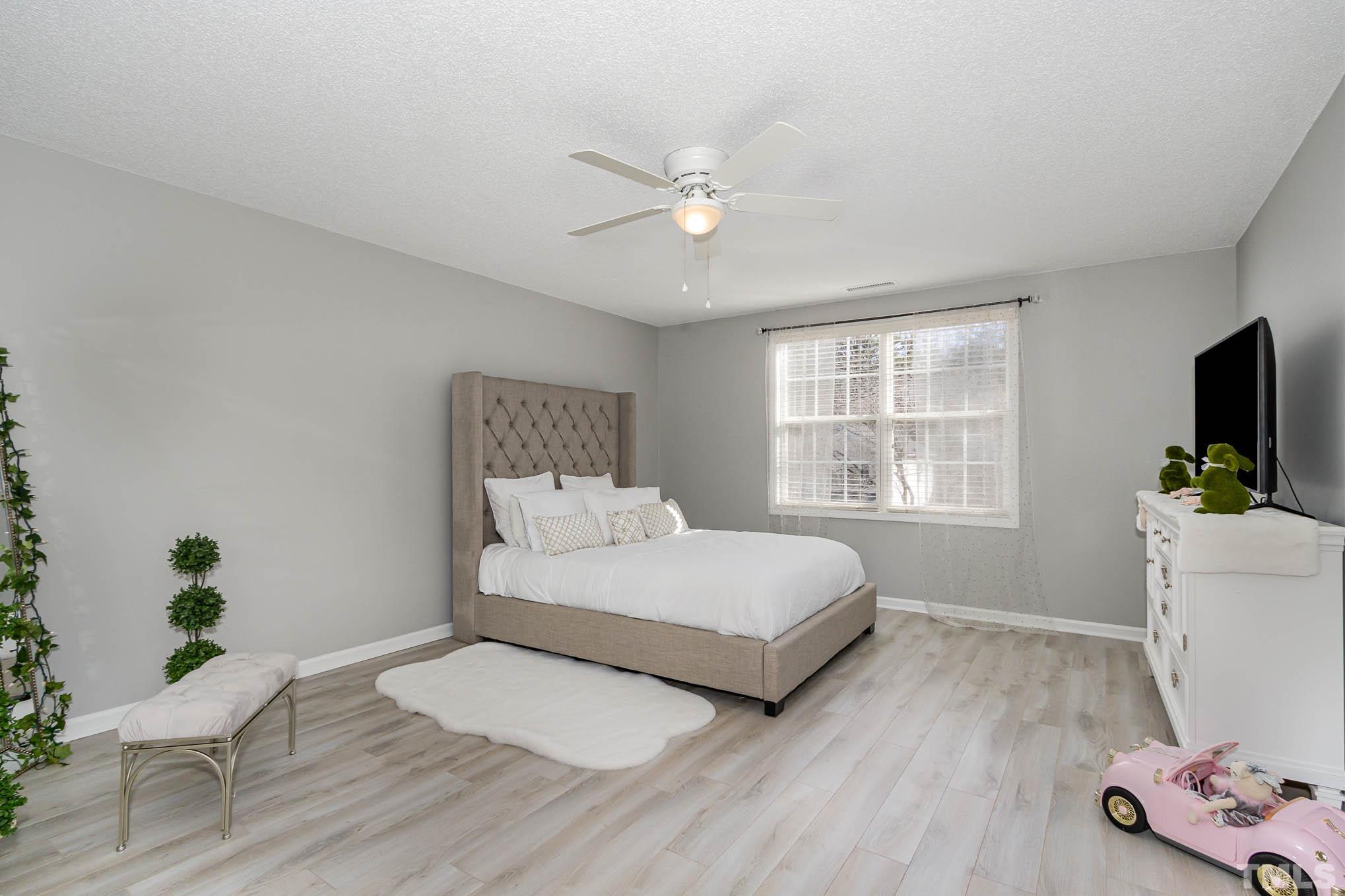 266 Inkster Cove Raleigh, NC 27603 - Photo 16 of 30 a bedroom with a bed and a window