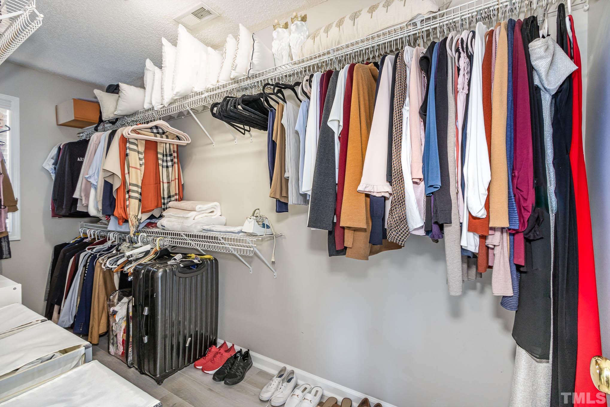 266 Inkster Cove Raleigh, NC 27603 - Photo 19 of 30 a view of walk in closet with clothes and shoes