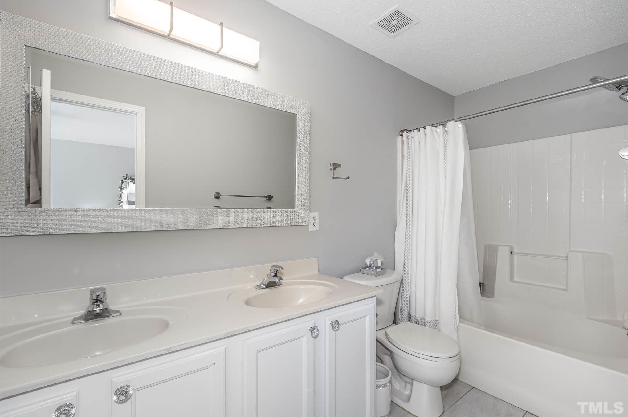 266 Inkster Cove Raleigh, NC 27603 - Photo 20 of 30 a bathroom with a double vanity sink mirror and toilet