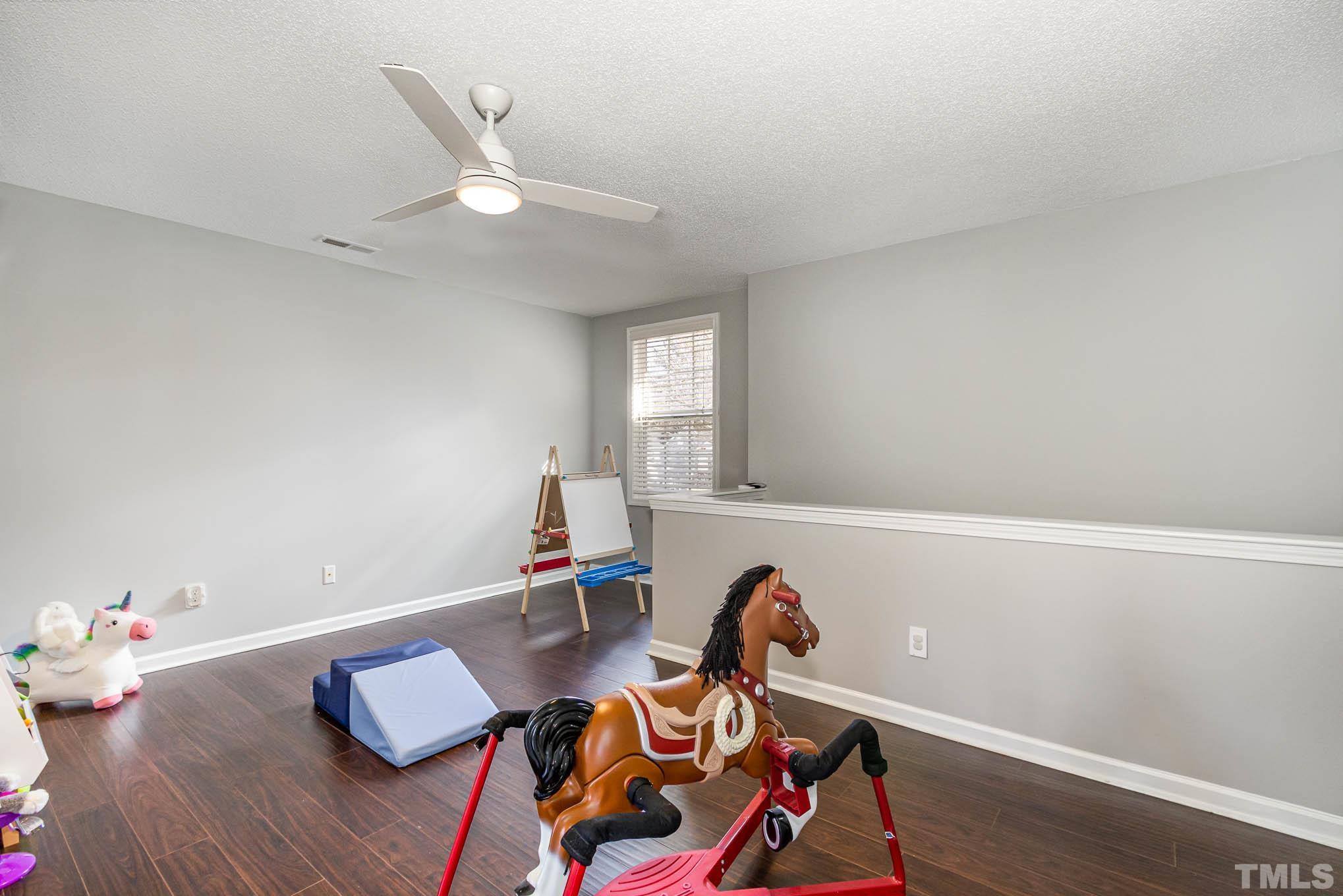 266 Inkster Cove Raleigh, NC 27603 - Photo 22 of 30 a living room with furniture and wooden floor