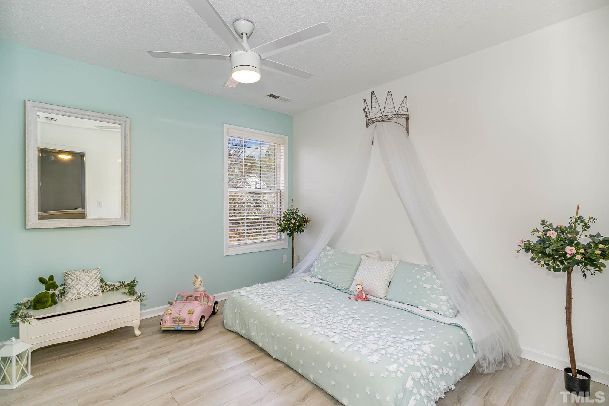 266 Inkster Cove Raleigh, NC 27603 - Photo 24 of 30 a bedroom with a bed and a potted plant