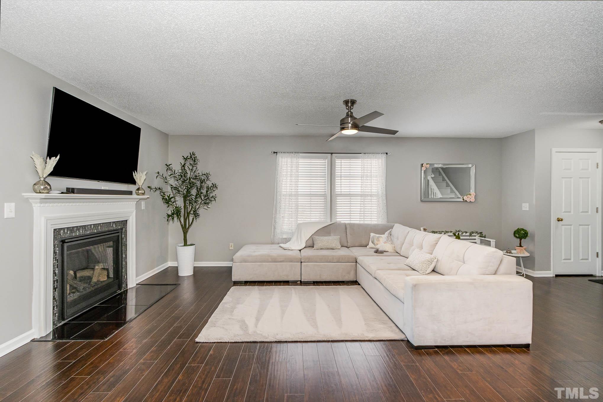 266 Inkster Cove Raleigh, NC 27603 - Photo 5 of 30 a living room with furniture fireplace and flat screen tv