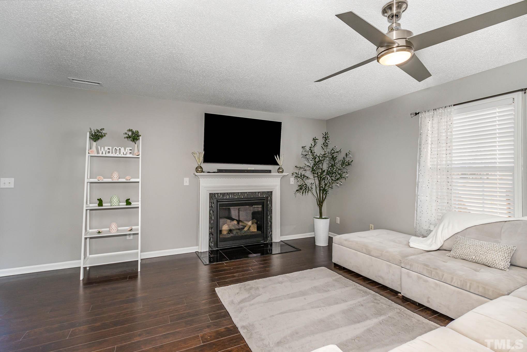 266 Inkster Cove Raleigh, NC 27603 - Photo 6 of 30 a living room with furniture fireplace and window