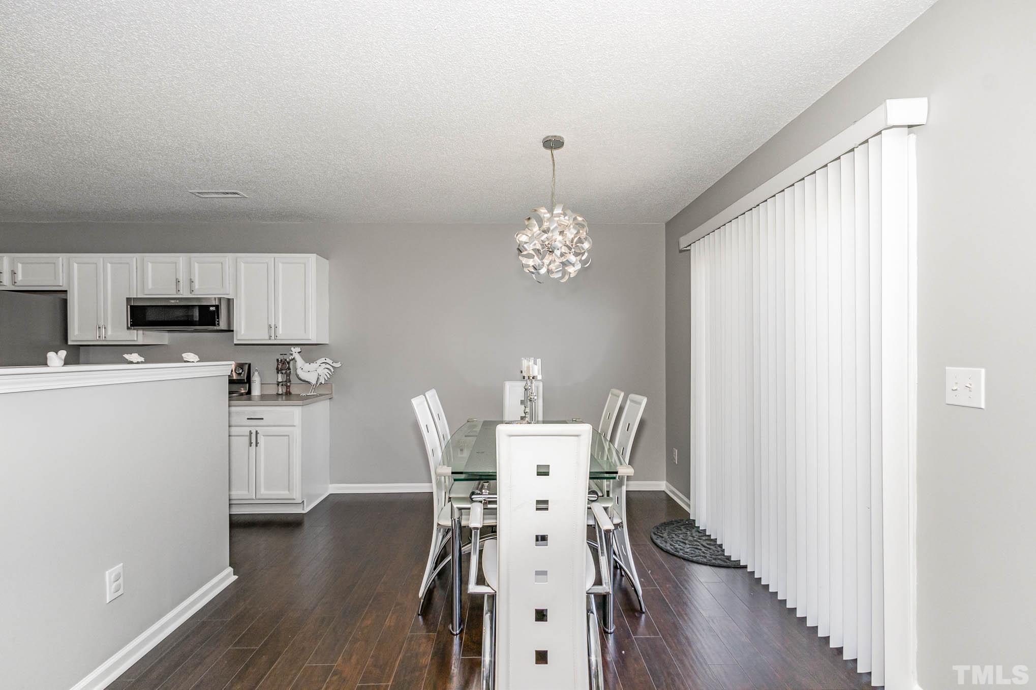 266 Inkster Cove Raleigh, NC 27603 - Photo 7 of 30 a view of a dining room with furniture window and wooden floor