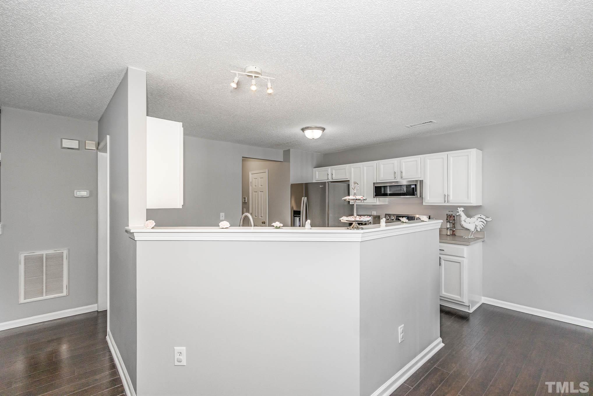 266 Inkster Cove Raleigh, NC 27603 - Photo 9 of 30 a view of open kitchen with wooden floor