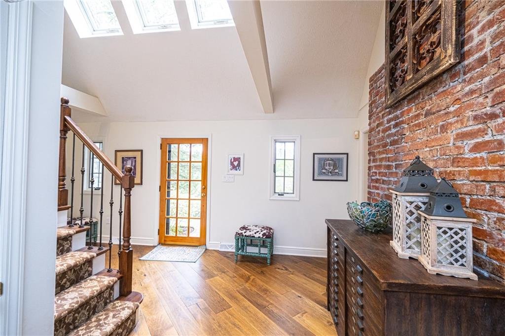 TWO STORY ENTRY WITH SKYLIGHTS AND CUSTOM IRON AND WOOD RAILING
