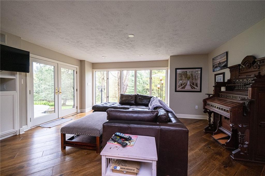 LIVING ROOM WITH TONS OF WINDOW AND FIREPLACE