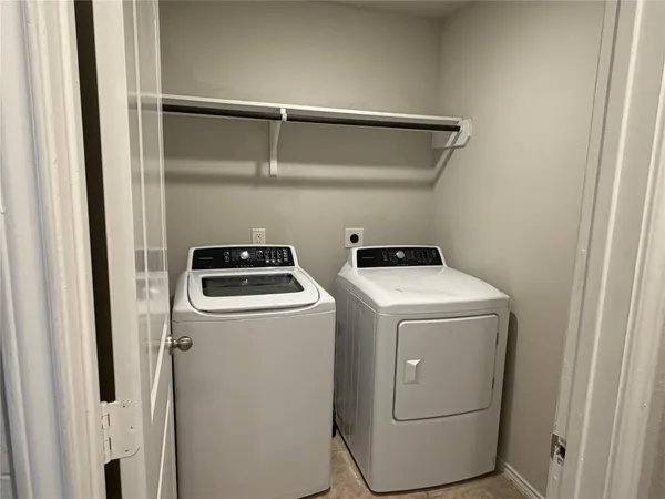 a view of a big room with windows and chandelier fan