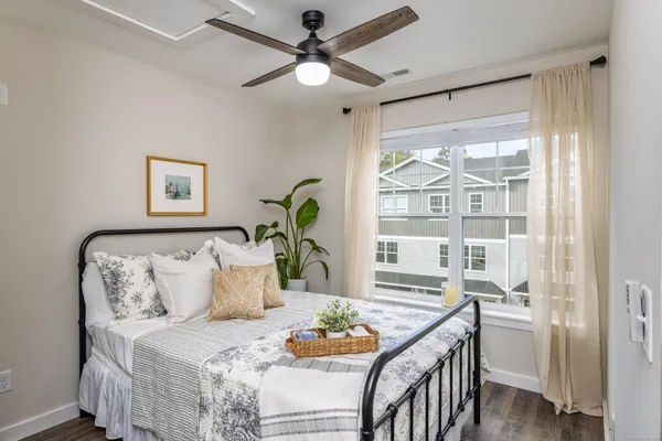 a bedroom with furniture and a large window