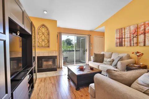a living room with fireplace furniture and a flat screen tv