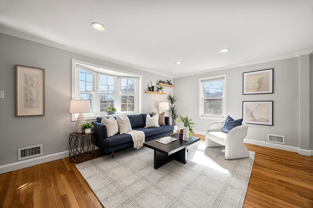 7 Bow Street, Unit 7 Arlington, MA 02474 - Photo 2 of 18 a living room with furniture and a large window