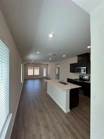a view of kitchen with sink and wooden floor