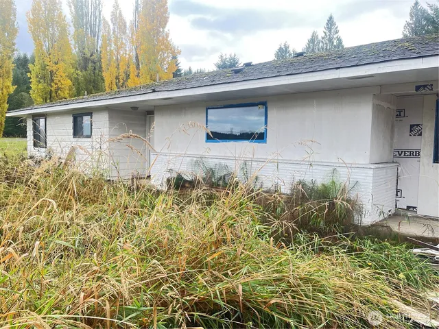 a side view of a house with a yard