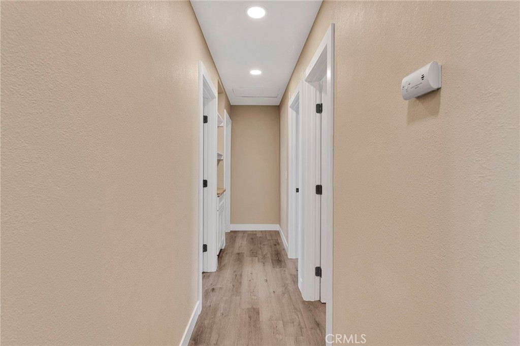 15471 Washoan Road Apple Valley, CA 92307 - Photo 14 of 38 a view of a hallway with wooden floor