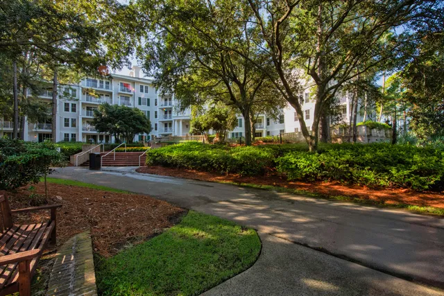 a view of a street with a building and trees in the background