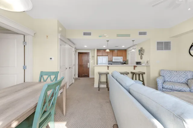 a living room with furniture a flat screen tv and a window
