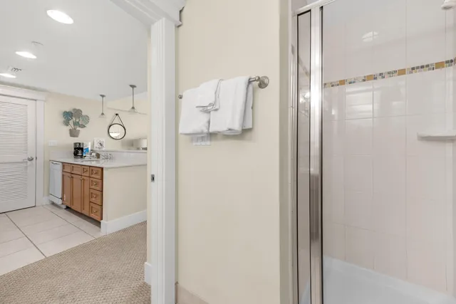 a white toilet sitting next to a bathroom sink and vanity